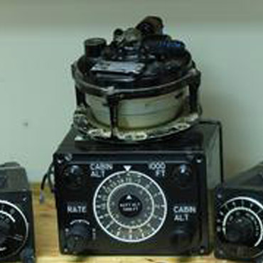 A couple of old radio units sitting on top of a table.
